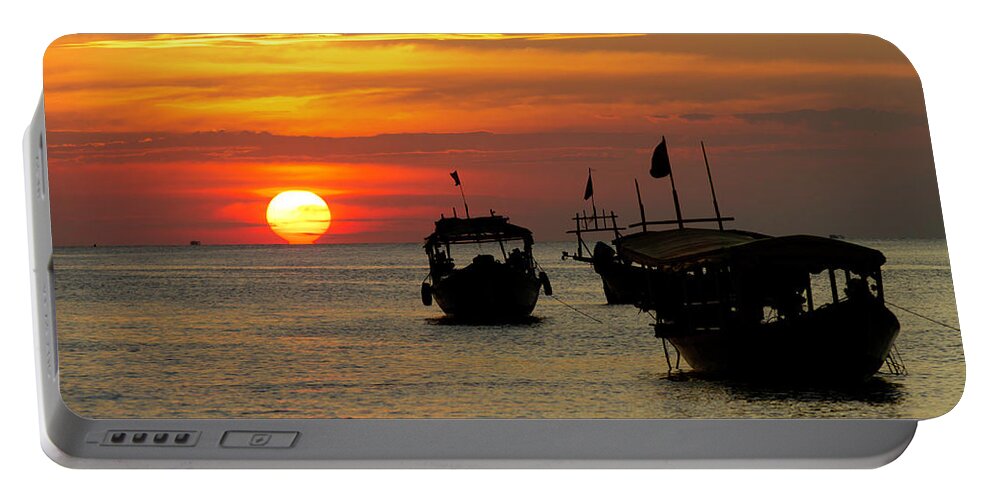 Sunset Portable Battery Charger featuring the photograph As the sun meets the sea by David Freuthal