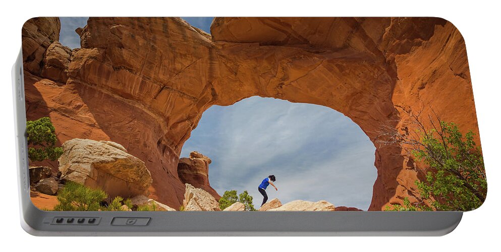 Arches Portable Battery Charger featuring the photograph Balancing under an Arch by Agnes Caruso