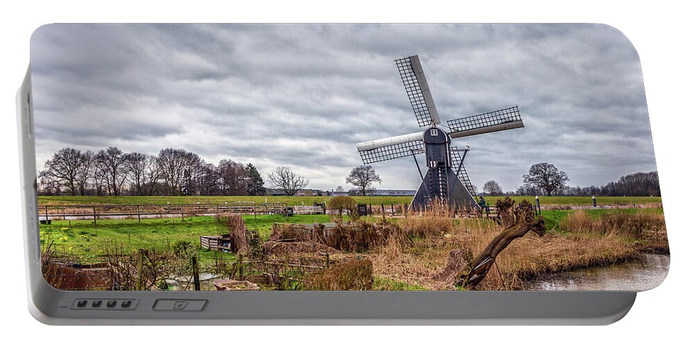 Windmill Portable Battery Charger featuring the photograph Beautiful landscape with a spiderhead mill in the Netherlands by Tim Abeln