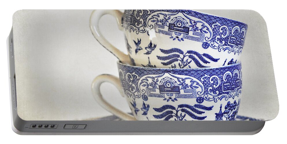 Cups Portable Battery Charger featuring the photograph Blue and white stacked china. by Lyn Randle