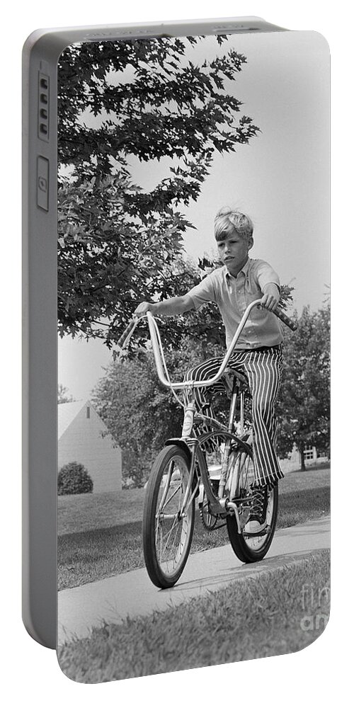 1970s Portable Battery Charger featuring the photograph Boy Riding Bike On Suburban Sidewalk by H. Armstrong Roberts/ClassicStock