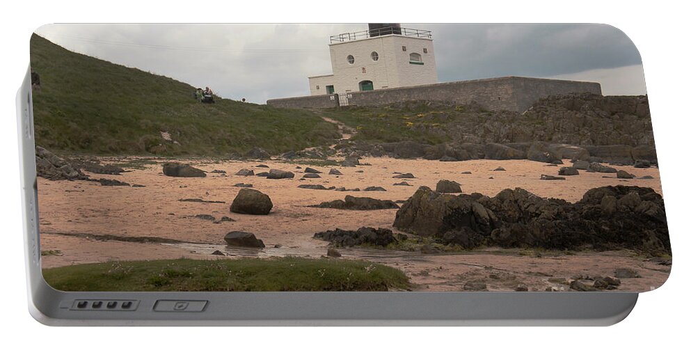 Lighthouse Portable Battery Charger featuring the photograph Clouds over Bamburgh Lighthouse by Elena Perelman