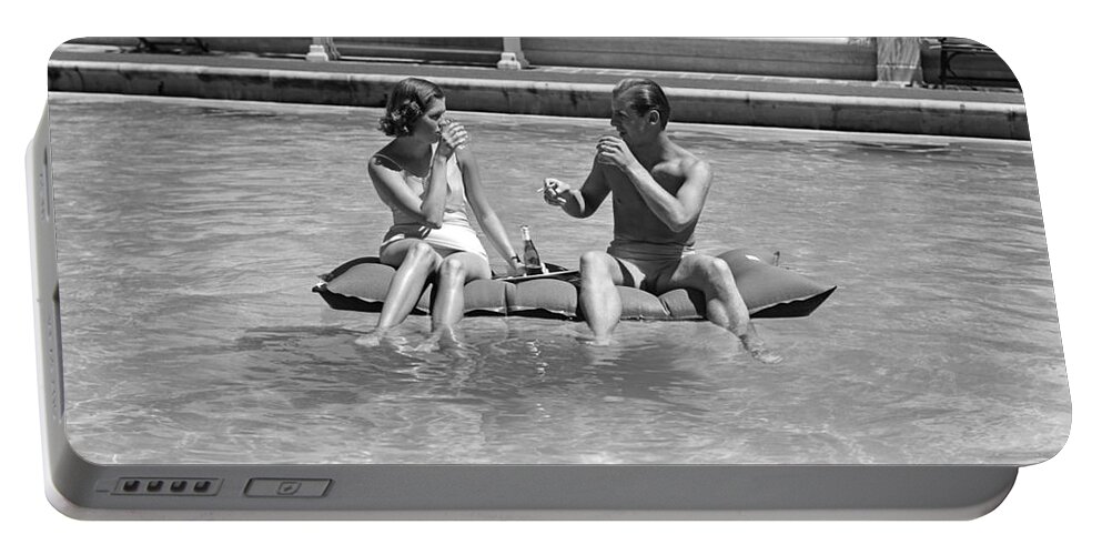 1930s Portable Battery Charger featuring the photograph Couple Relaxing In Pool, C.1930-40s by H Armstrong Roberts and ClassicStock