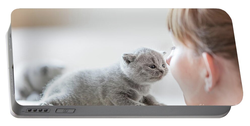 Cat Portable Battery Charger featuring the photograph Cute little cat and woman rubbing noses. by Michal Bednarek