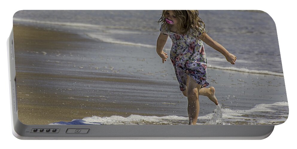 Dancing Portable Battery Charger featuring the photograph Dancing in the surf with a pink pacifier by WAZgriffin Digital