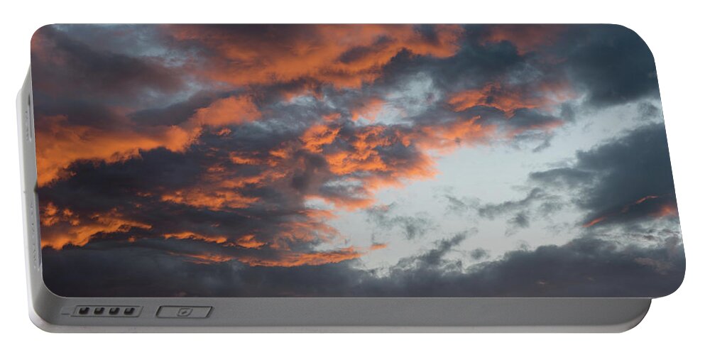 Stormy Clouds Portable Battery Charger featuring the photograph Dramatic sunset sky with orange cloud colors by Michalakis Ppalis