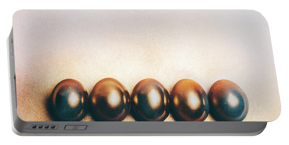 Egg Portable Battery Charger featuring the photograph Five golden eggs laying on the floor. by Michal Bednarek