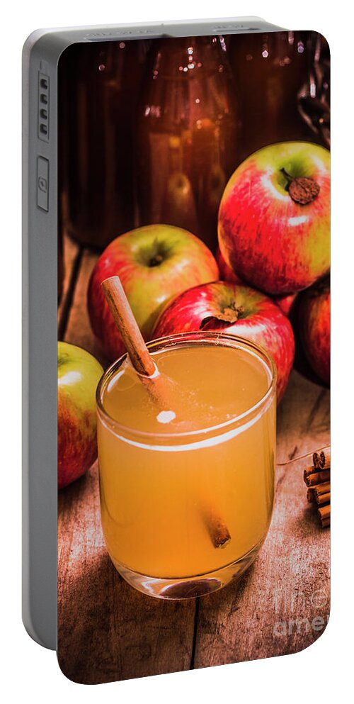 Apple Portable Battery Charger featuring the photograph Glass of fresh apple cider by Jorgo Photography