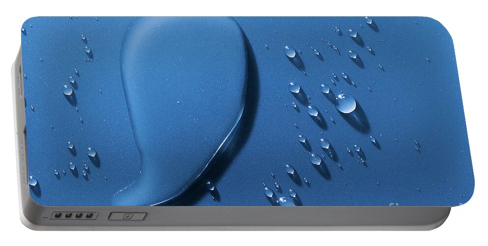 Water Portable Battery Charger featuring the photograph Large and small water droplets viewed from above by Simon Bratt