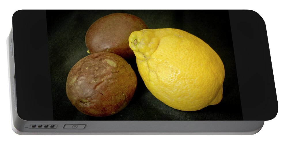 Still Life Portable Battery Charger featuring the photograph Lemon and a pair of Passion fruit. by Elena Perelman