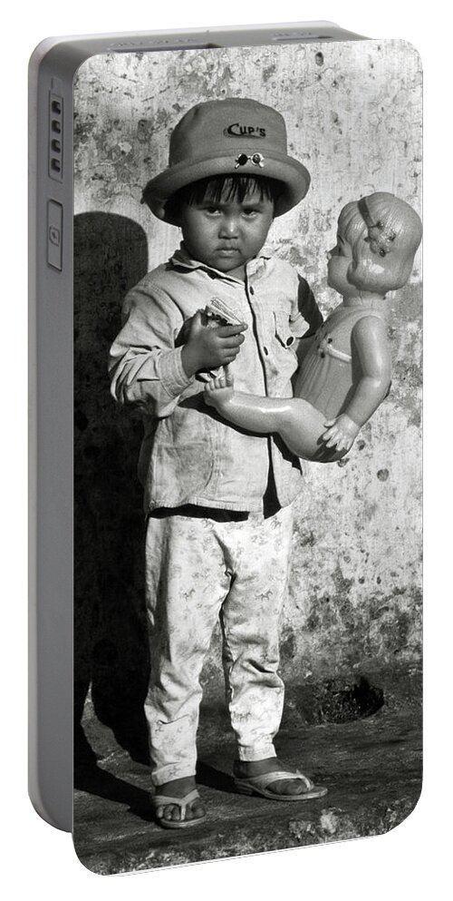 Girl Portable Battery Charger featuring the photograph Little Vietnamese girl playing with her doll by Silva Wischeropp