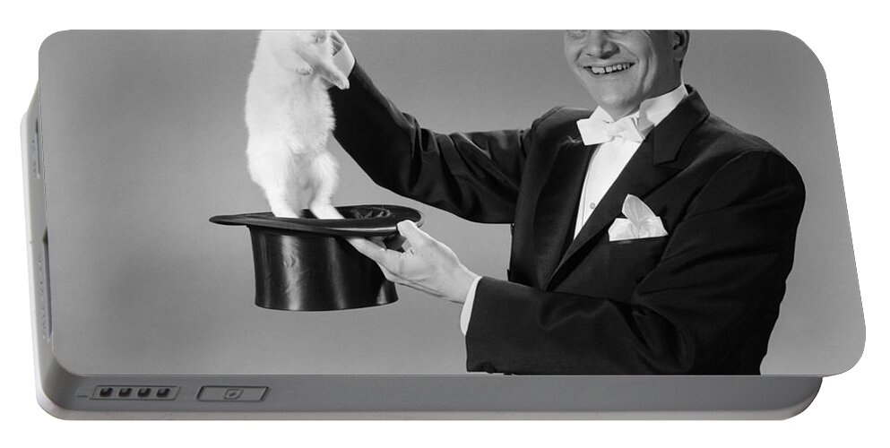 1960s Portable Battery Charger featuring the photograph Magician Pulling Rabbit Out Of Hat by H. Armstrong Roberts/ClassicStock