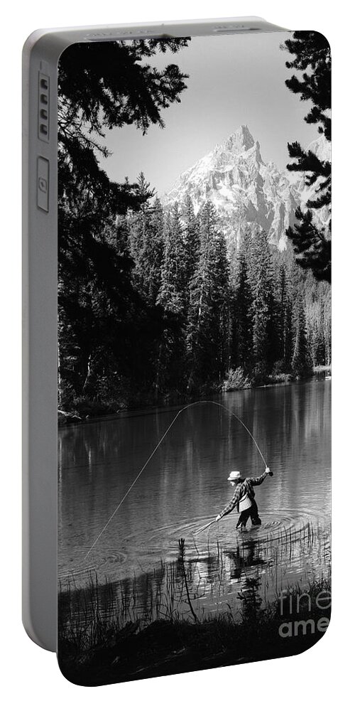 1960s Portable Battery Charger featuring the photograph Man Fishing With Net And Rod by D. Corson/ClassicStock