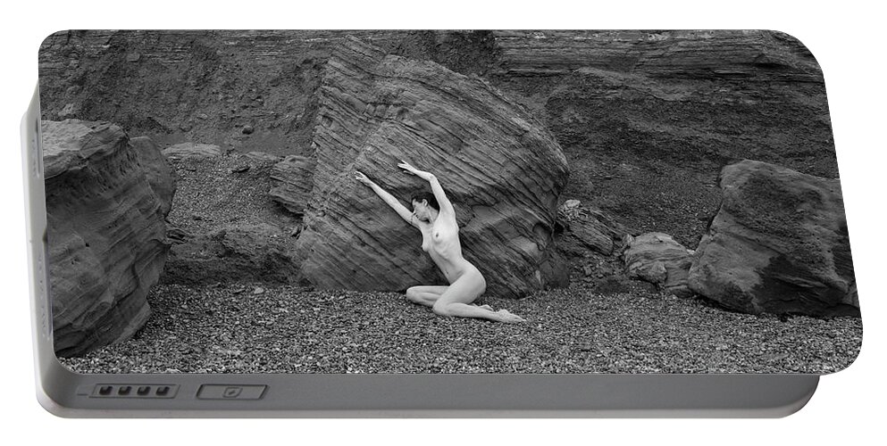 Woman Portable Battery Charger featuring the photograph Nude woman pulling shape by rocks by Clayton Bastiani