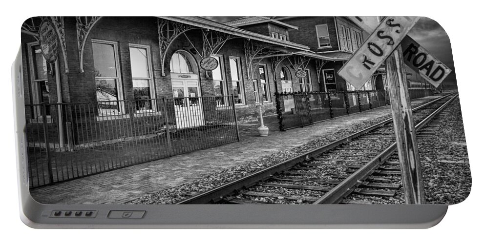 Station Portable Battery Charger featuring the photograph Old Train Station with Crossing Sign in Black and White by Randall Nyhof