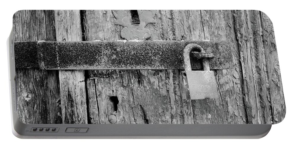 Padlock On An Old Wooden Door Portable Battery Charger featuring the photograph Padlock On An Old Wooden Door by Marco Oliveira