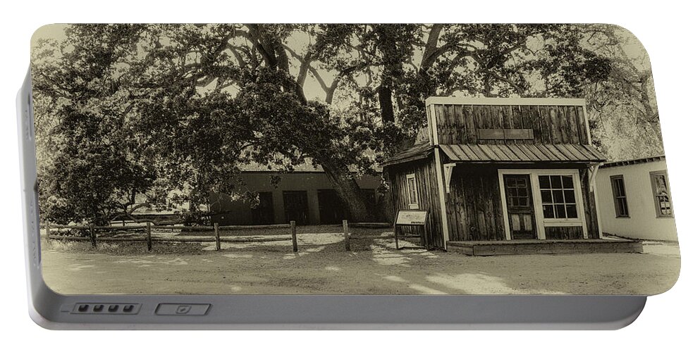 Ghost Town Portable Battery Charger featuring the photograph Paramount Ranch Barber Shop And Stable - b/w by Gene Parks