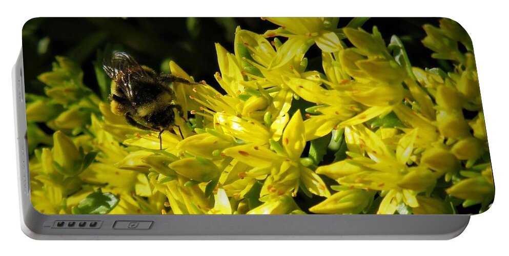 Photograph Portable Battery Charger featuring the photograph Photograph of a Bee on Yellow Flowers by Delynn Addams