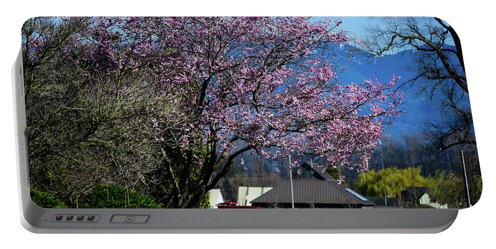 Pink Tree Red Trailer Portable Battery Charger featuring the photograph Pink Tree Red Trailer by Tom Cochran