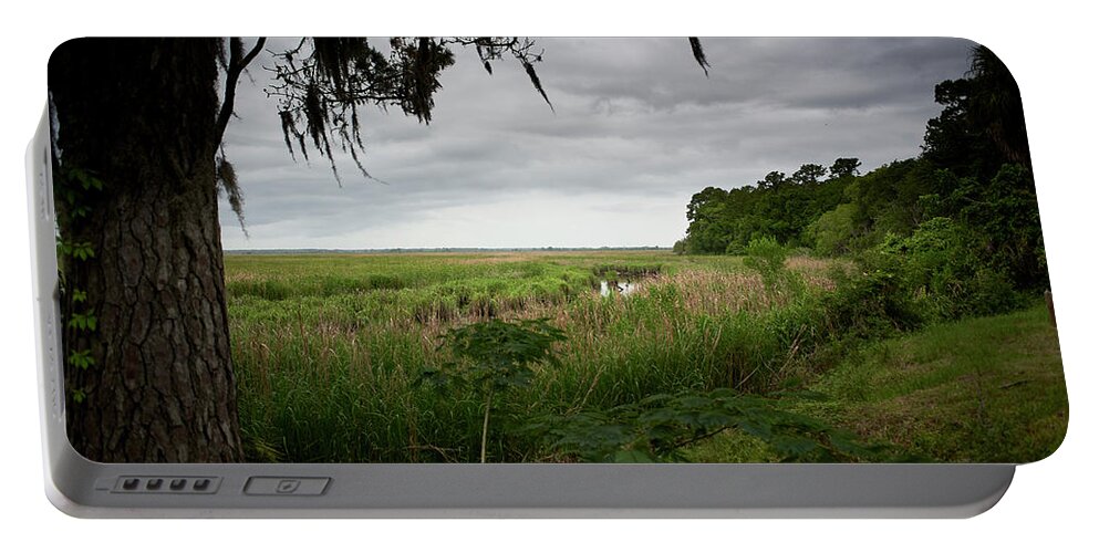 Marsh Portable Battery Charger featuring the photograph Rain clouds and marsh by John Simmons