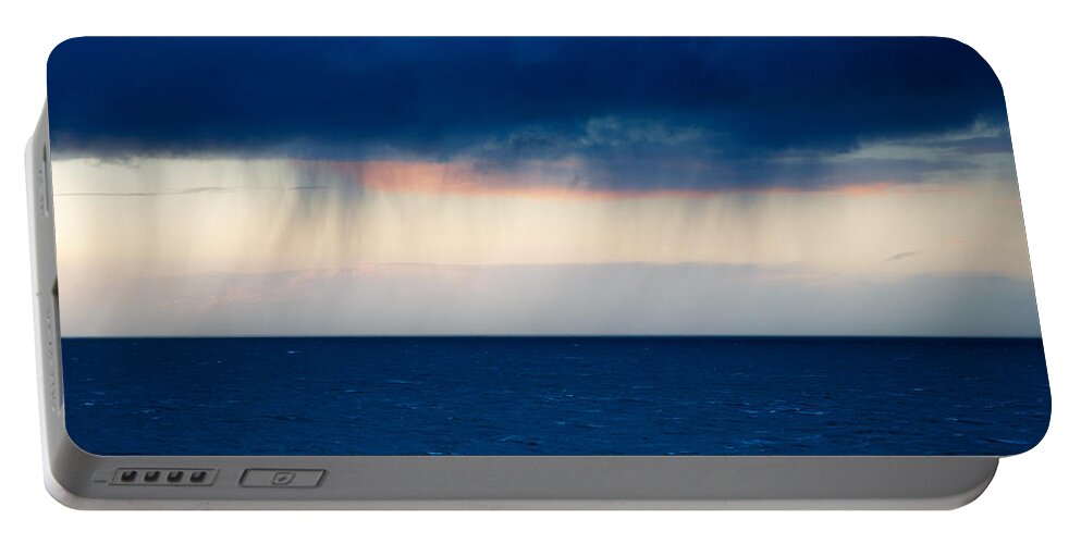 Rain Portable Battery Charger featuring the photograph Rain on the horizon at Strumble Head by Ian Middleton