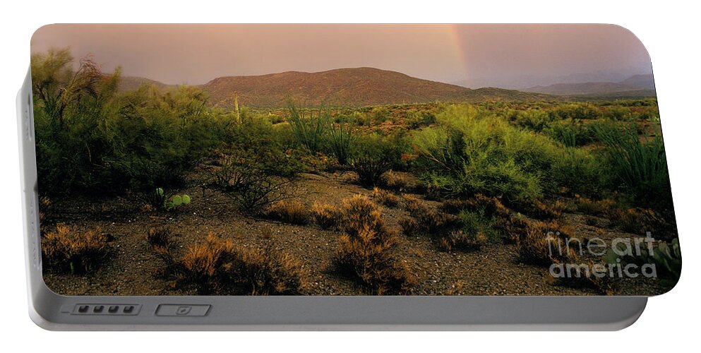 Rainbow Portable Battery Charger featuring the photograph Rain Upon the Desert Land by Wernher Krutein