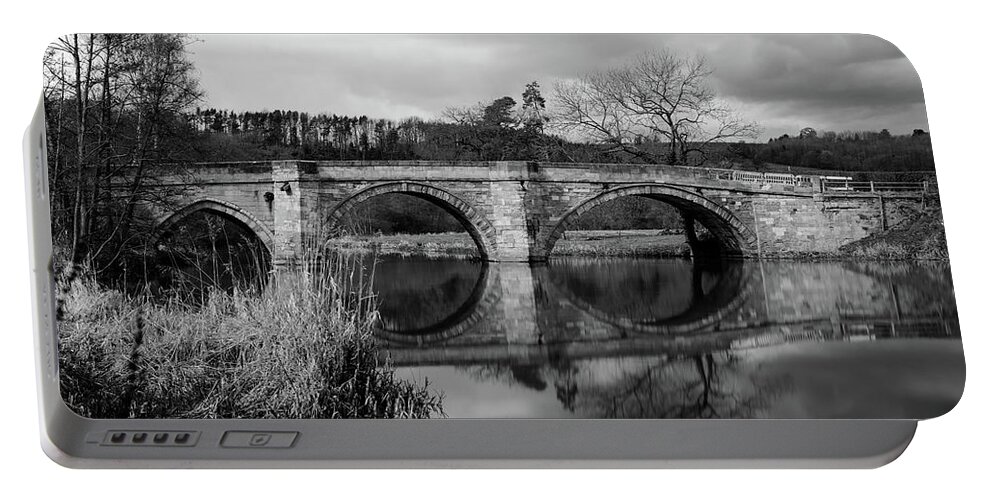 B & W Portable Battery Charger featuring the photograph Reflecting Oval Stone Bridge in Blanc and White by Dennis Dame
