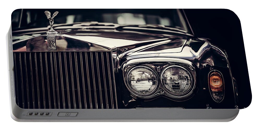 Car Portable Battery Charger featuring the photograph Rolls-Royce - classic British car on black background, close-up. by Michal Bednarek
