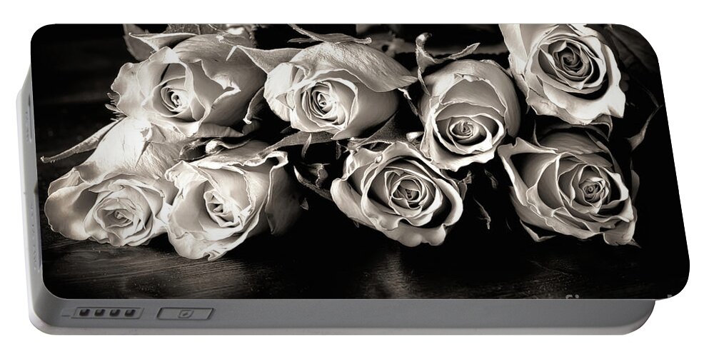 Roses Portable Battery Charger featuring the photograph Roses on a table in black and white by Simon Bratt