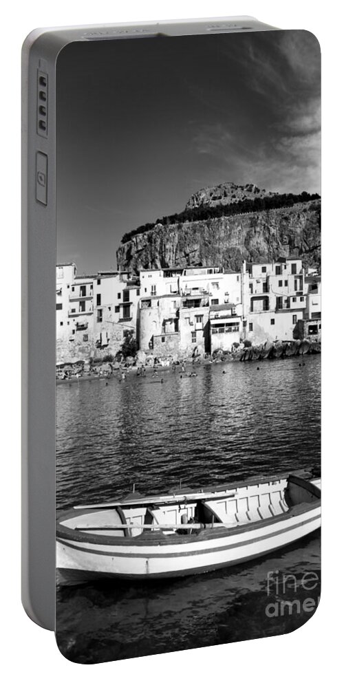 Fishing Boat Portable Battery Charger featuring the photograph Rowboat along an idyllic Sicilian village. by Stefano Senise