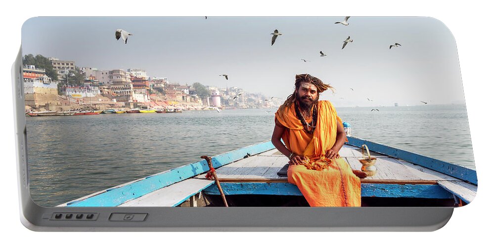 Asia Portable Battery Charger featuring the photograph Sadhu in a boat. by Usha Peddamatham