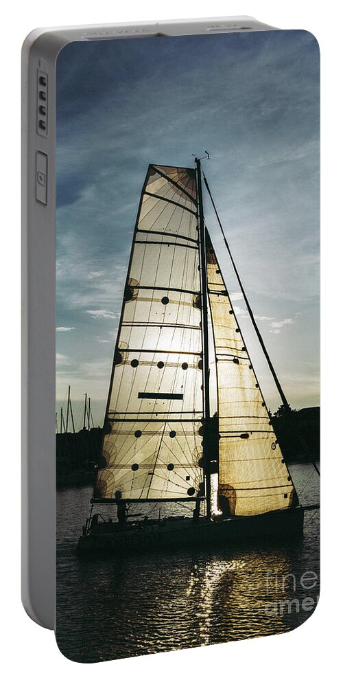 Active Portable Battery Charger featuring the photograph Sailboat in Front of Sun in Harbor by Andreas Berthold