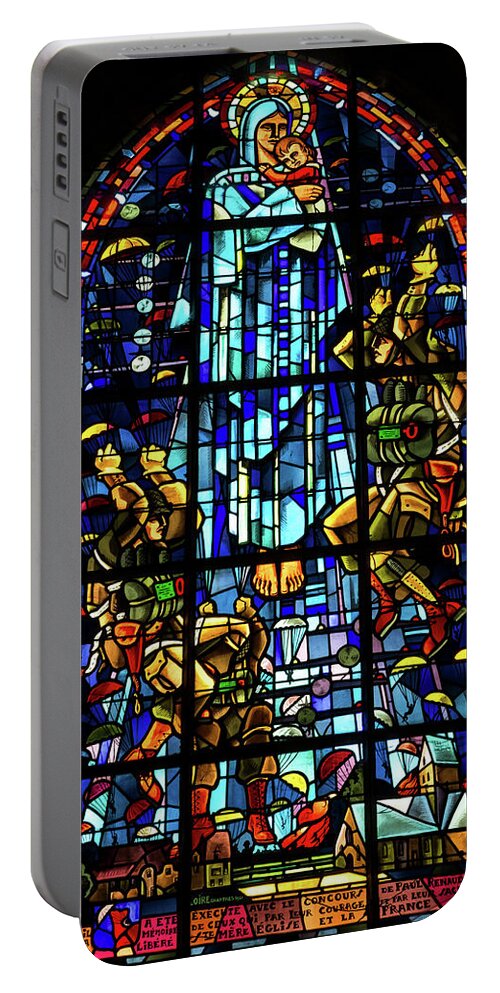 Sainte-mere-eglise Portable Battery Charger featuring the photograph Sainte-Mere-Eglise Paratrooper Tribute Stained Glass Window by John Daly