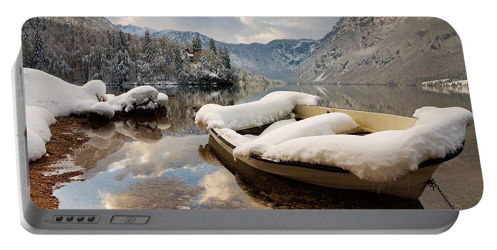 Bohinj Portable Battery Charger featuring the photograph Snow covered boat on Lake Bohinj in Winter by Ian Middleton