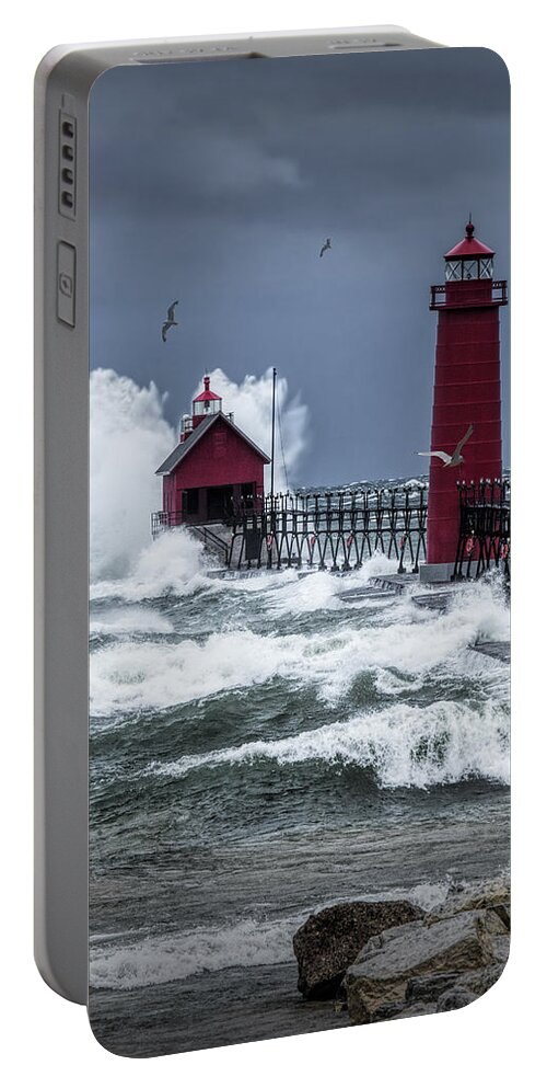 Lighthouse Portable Battery Charger featuring the photograph Storm on Lake Michigan by the Grand Haven Lighthouse with Flying Gulls by Randall Nyhof