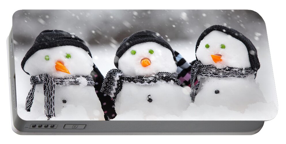 Christmas Portable Battery Charger featuring the photograph Three cute snowmen by Simon Bratt