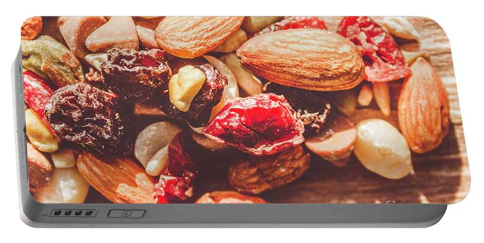 Almond Portable Battery Charger featuring the photograph Trail mix high-energy snack food background by Jorgo Photography