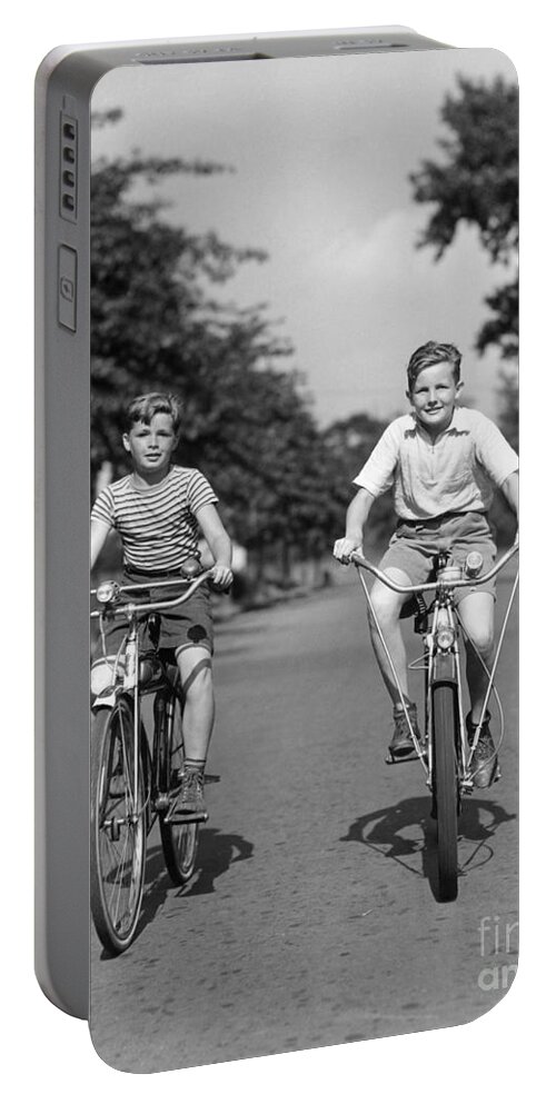 1930s Portable Battery Charger featuring the photograph Two Boys Riding Bikes, C.1930-40s by H Armstrong Roberts ClassicStock