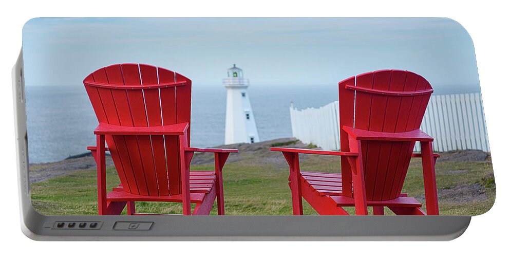 Adirondack Chairs Portable Battery Charger featuring the photograph Two Red Adirondack Chairs looking out to a Lighthouse by Art Whitton