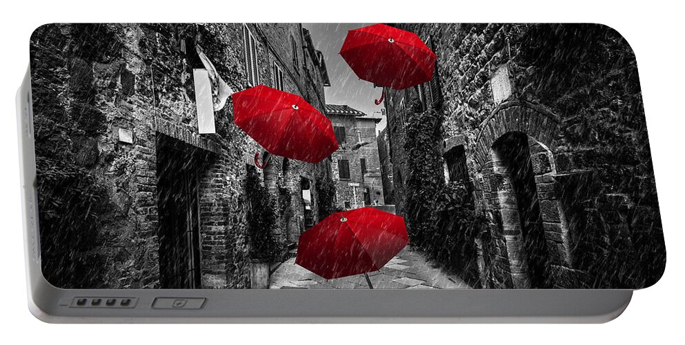 Italian Portable Battery Charger featuring the photograph Umrbellas flying with wind and rain on dark street in an old Italian town in Tuscany, Italy by Michal Bednarek