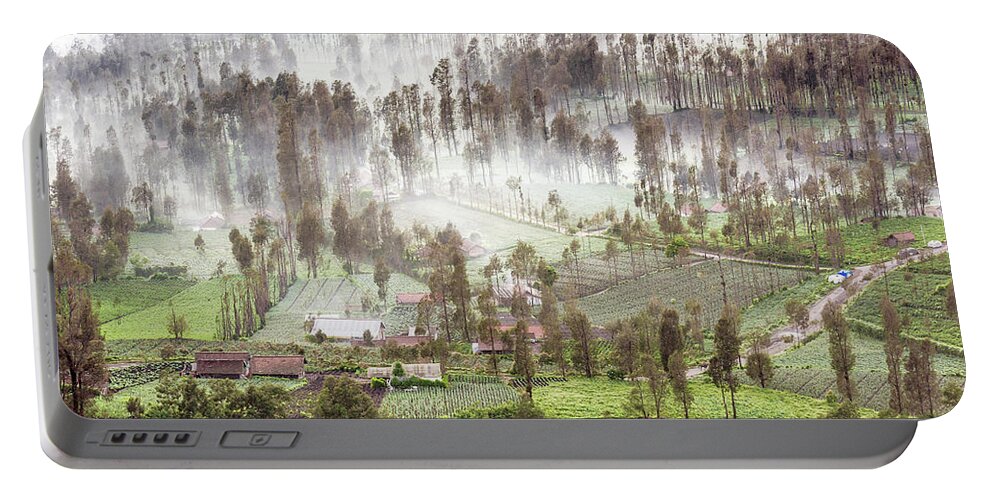 Landscape Portable Battery Charger featuring the photograph Village covered with mist by Pradeep Raja Prints