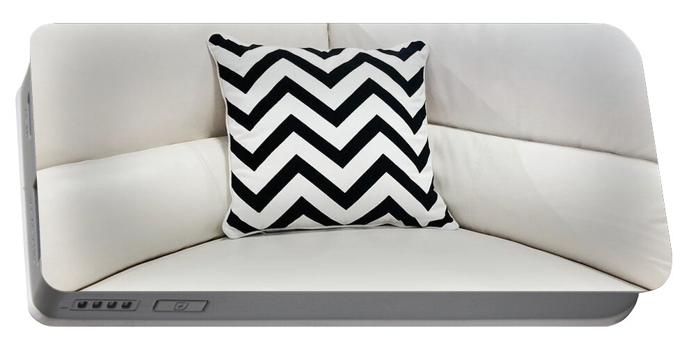 Sofa Portable Battery Charger featuring the photograph White leather sofa with decorative cushion by GoodMood Art