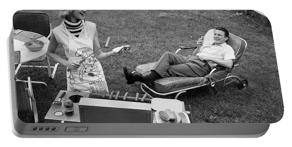 1950s Portable Battery Charger featuring the photograph Woman Grilling Hot Dogs For Man by Debrocke/ClassicStock