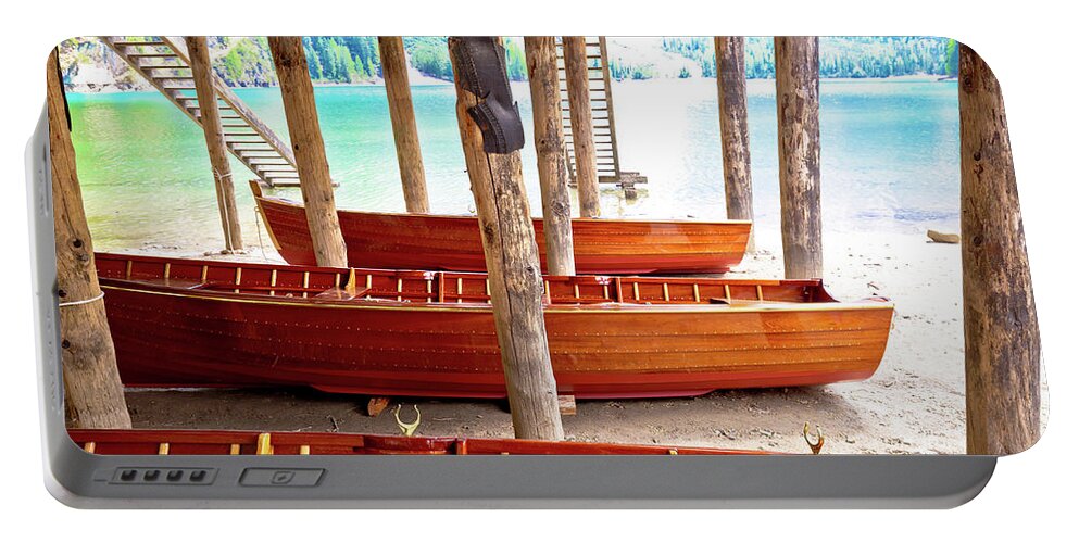 Prags Portable Battery Charger featuring the photograph Wooden boats under boat house on Braies lake by Brch Photography