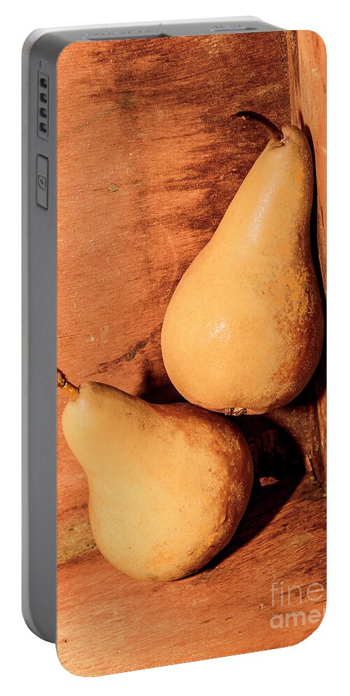 Pear Portable Battery Charger featuring the photograph Yellow colored pears on wooden background by Jorgo Photography