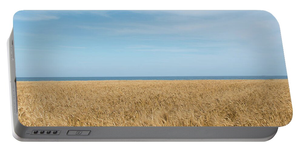 Background Portable Battery Charger featuring the photograph Yellow field, sea and blue sky by Michalakis Ppalis
