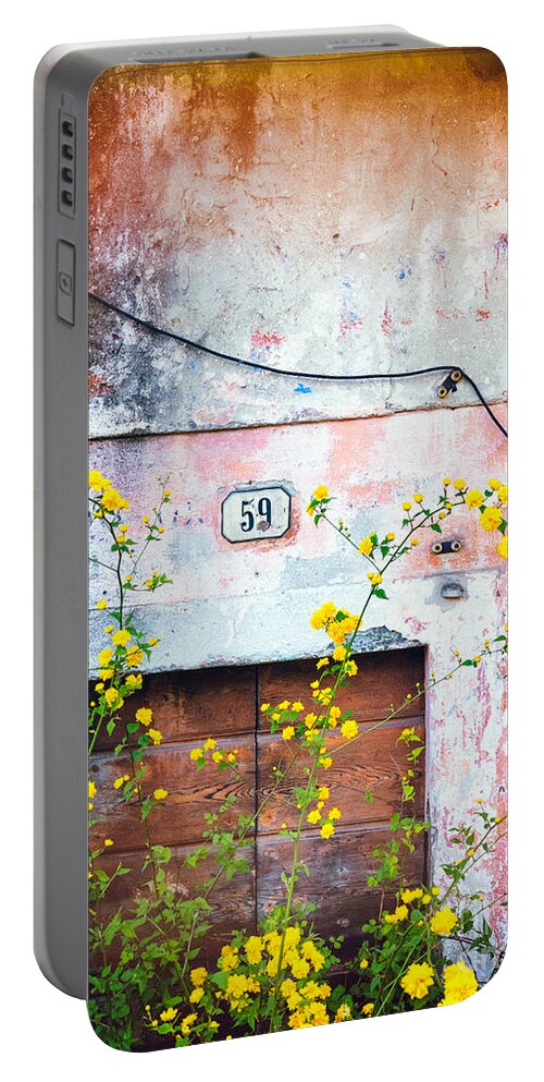 Architecture Portable Battery Charger featuring the photograph Yellow flowers and decayed wall by Silvia Ganora