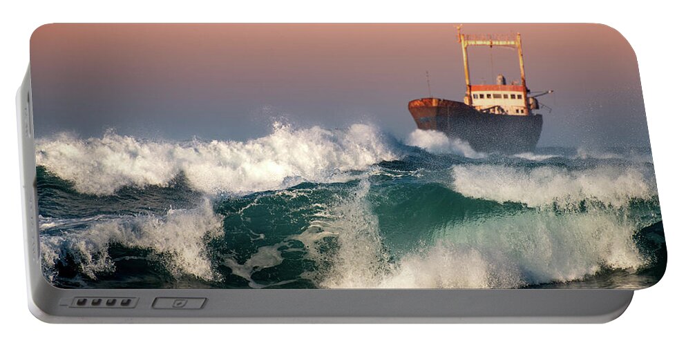Sea Portable Battery Charger featuring the photograph Abandoned Ship and the stormy waves by Michalakis Ppalis