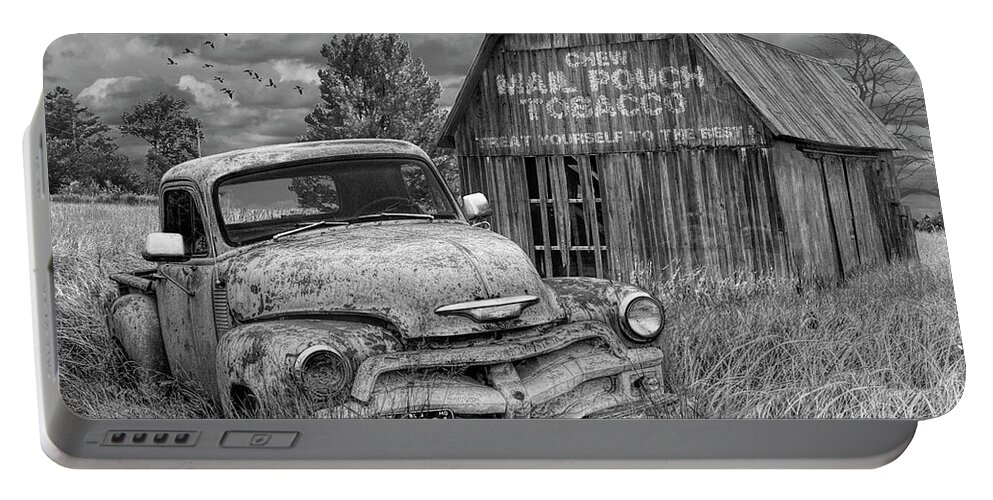 Chevy Portable Battery Charger featuring the photograph Black and White of Rusted Chevy Pickup Truck in a Rural Landscape by a Mail Pouch Tobacco Barn by Randall Nyhof
