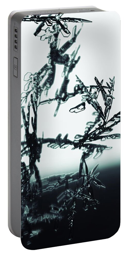 Abstract Portable Battery Charger featuring the photograph Broken snowflakes - monochrome blue by Intensivelight